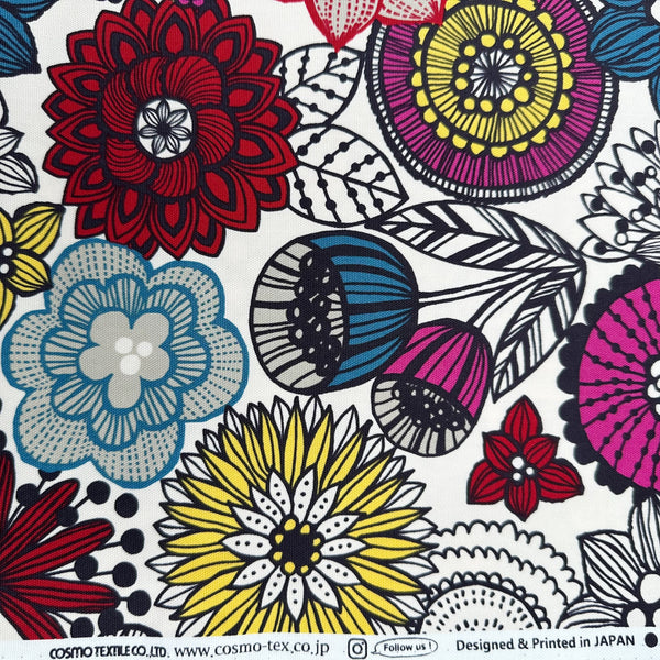 Selvage of Nordic Flower cotton oxford fabric by Cosmo Textiles featuring a graphic floral print on a natural background.
