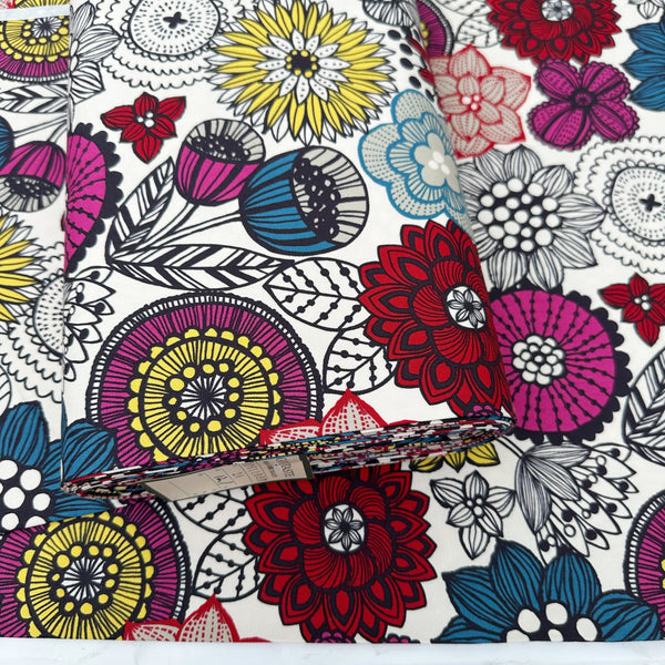 Bolt of Nordic Flower cotton oxford fabric by Cosmo Textiles featuring a graphic floral print on a natural background.