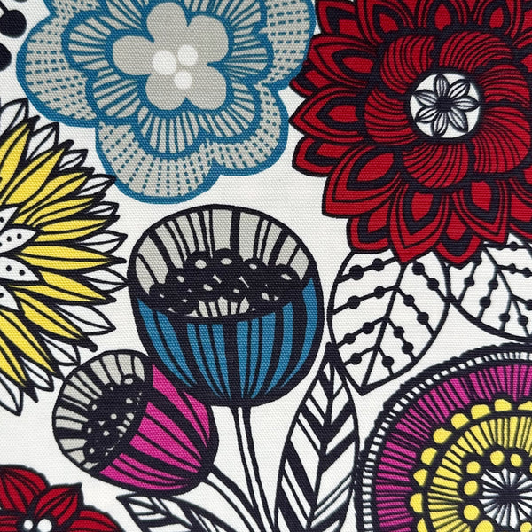 Close up of Nordic Flower cotton oxford fabric by Cosmo Textiles featuring a graphic floral print on a natural background.