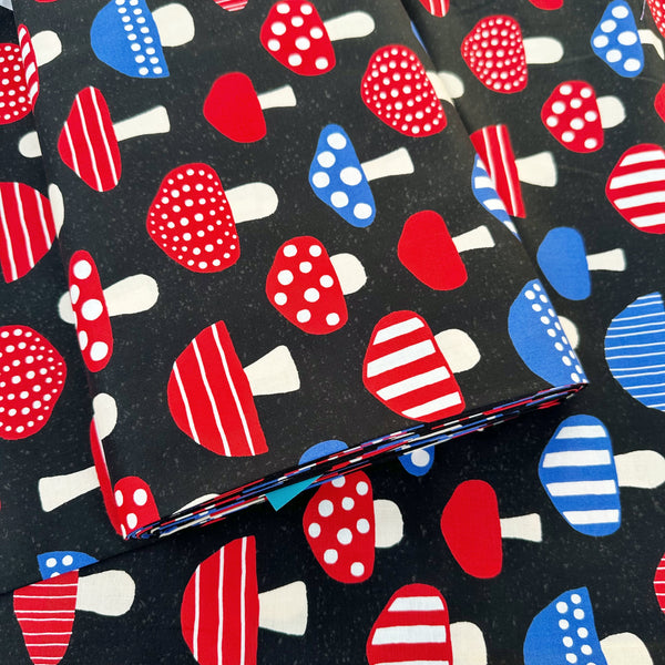 Bolt of Nordic Mushroom cotton fabric in black by Cosmo Textiles featuring Scandinavian-inspired mushroom illustrations imported from Japan