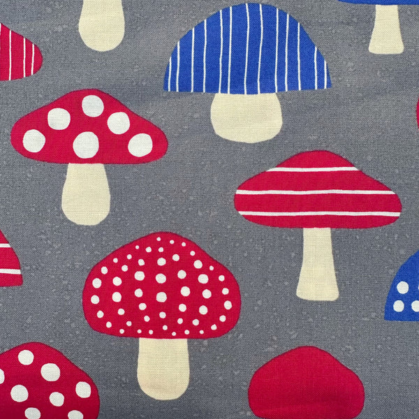 Close up of Nordic Mushroom cotton fabric in gray by Cosmo Textiles featuring Scandinavian-inspired mushroom illustrations imported from Japan