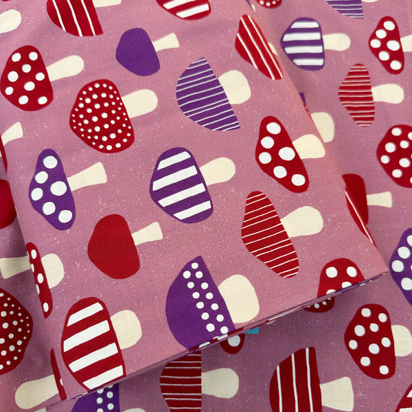 Bolt of Nordic Mushroom cotton fabric in mauve by Cosmo Textiles featuring Scandinavian-inspired mushroom illustrations imported from Japan