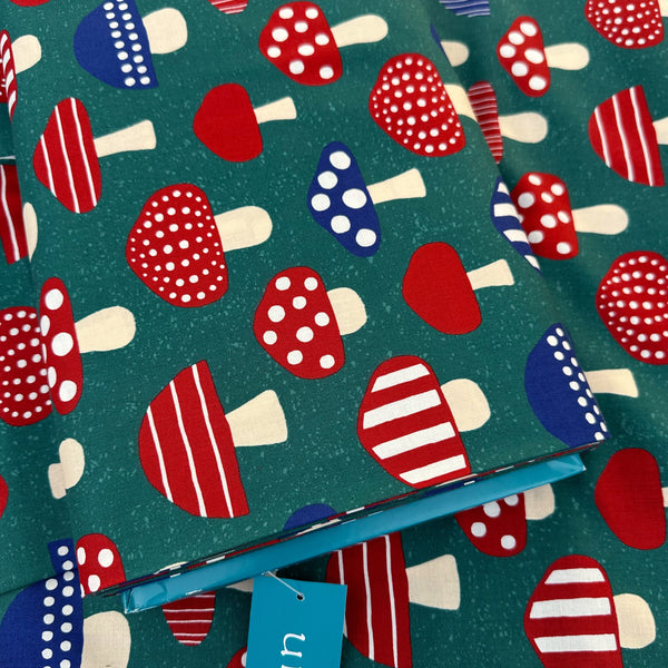 Bolt of Nordic Mushroom cotton fabric in teal by Cosmo Textiles featuring Scandinavian-inspired mushroom illustrations imported from Japan