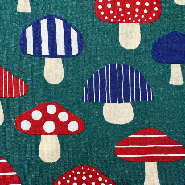 Close up of Nordic Mushroom cotton fabric in teal by Cosmo Textiles featuring Scandinavian-inspired mushroom illustrations imported from Japan