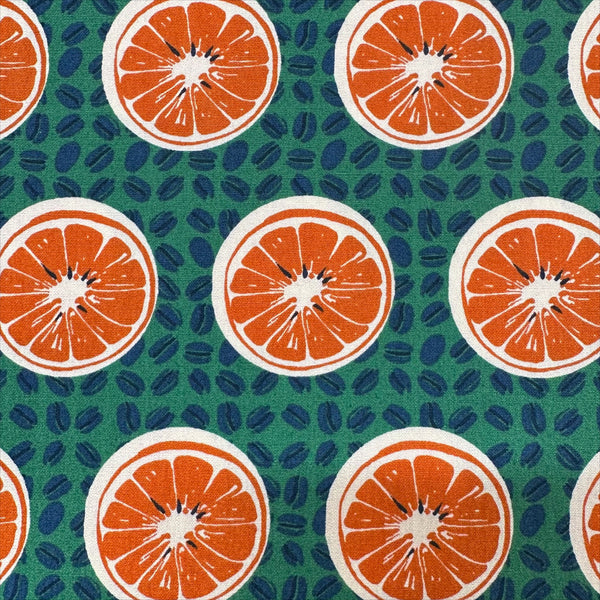Close up of Oranges and Coffee Beans cotton broadcloth fabric in green by Sevenberry, Japanese import featuring fruit and coffee bean print
