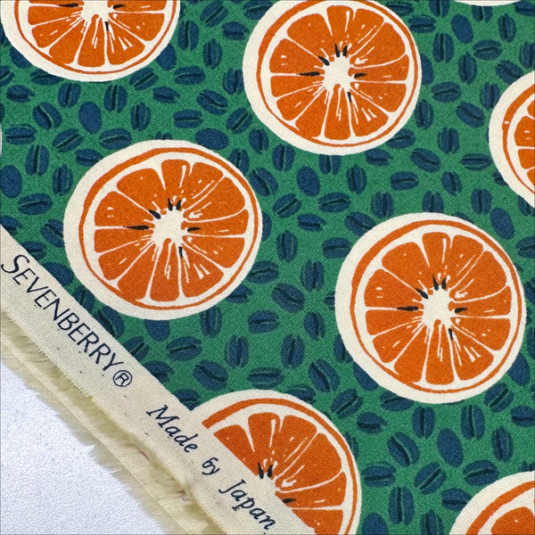 Selvage of Oranges and Coffee Beans cotton broadcloth fabric in green by Sevenberry, Japanese import featuring fruit and coffee bean print