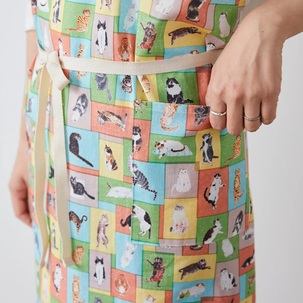 Apron made from Paper Message Cats in Tiny Room Cotton Fabric by Okubo Junko for Kokka Japan, featuring cats arranged in blocks in blue, orange, and yellow.