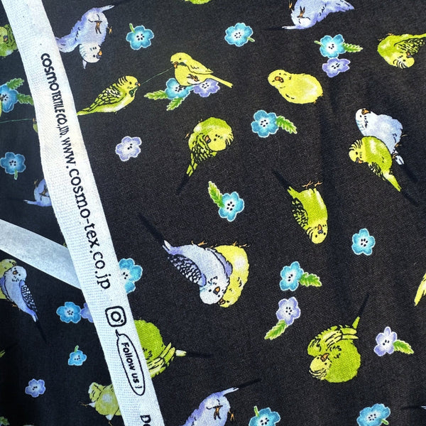 Selvage of Parakeet and Flower Cotton Fabric by Cosmo Textiles, style AP61903H 1F, featuring parakeets and flowers, in deep charcoal