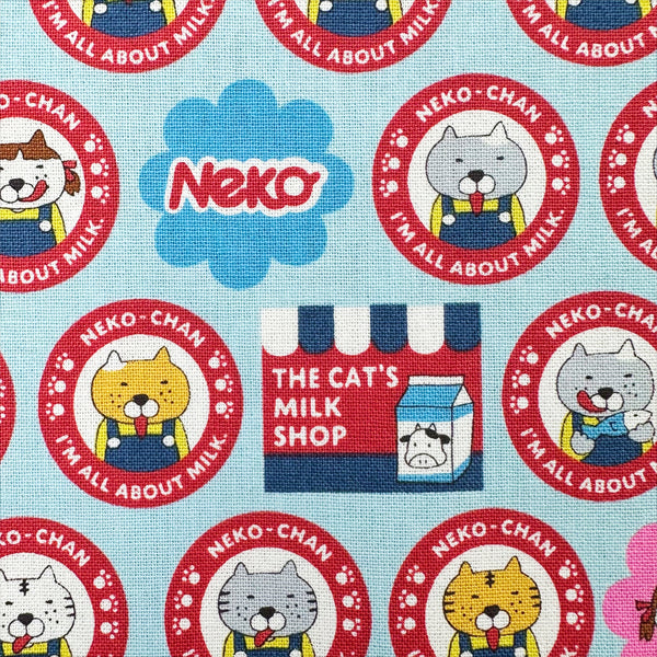 Close up of Pero Neko Cats cotton canvas fabric in blue by Cotton Kobayashi featuring playful illustrated cats, imported from Japan