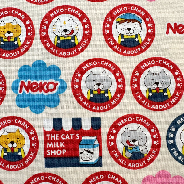 Close up of Pero Neko Cats cotton canvas fabric in ivory by Cotton Kobayashi featuring playful illustrated cats, imported from Japan