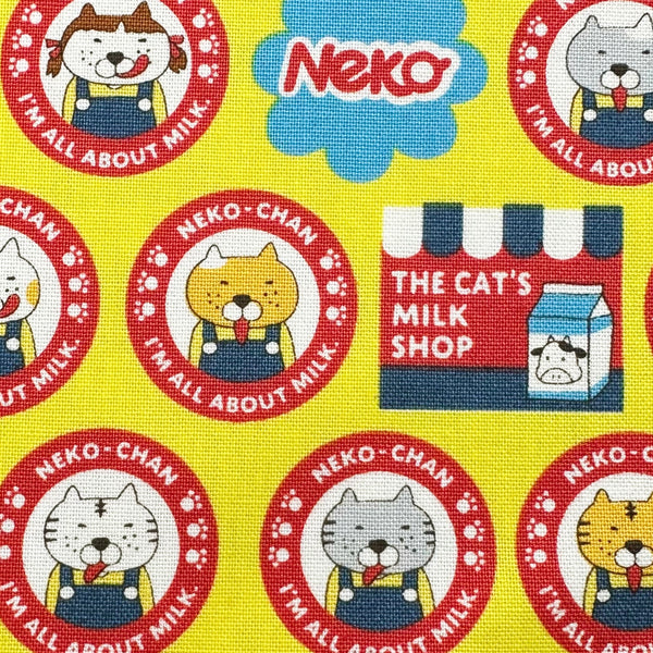 Close up of Pero Neko Cats cotton canvas fabric in yellow by Cotton Kobayashi featuring playful illustrated cats, imported from Japan