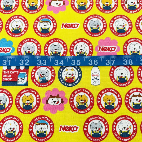 Scale of Pero Neko Cats cotton canvas fabric in yellow by Cotton Kobayashi featuring playful illustrated cats, imported from Japan