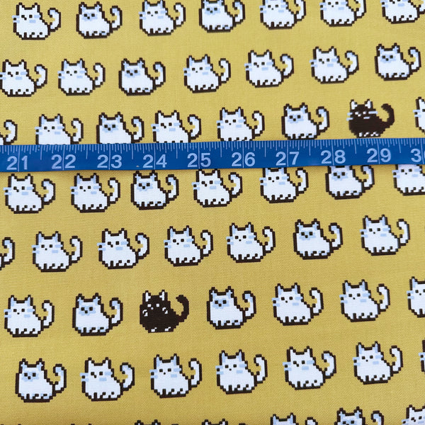 Scale of Pixel Cats cotton oxford fabric in golden mustard with playful pixel-style cat print, imported from Japan