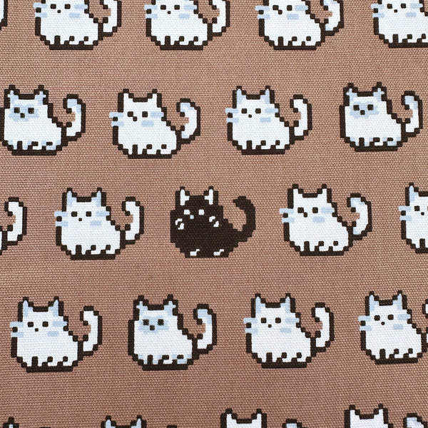 Close up of Pixel Cats cotton oxford fabric in mocha with playful pixel-style cat print, imported from Japan