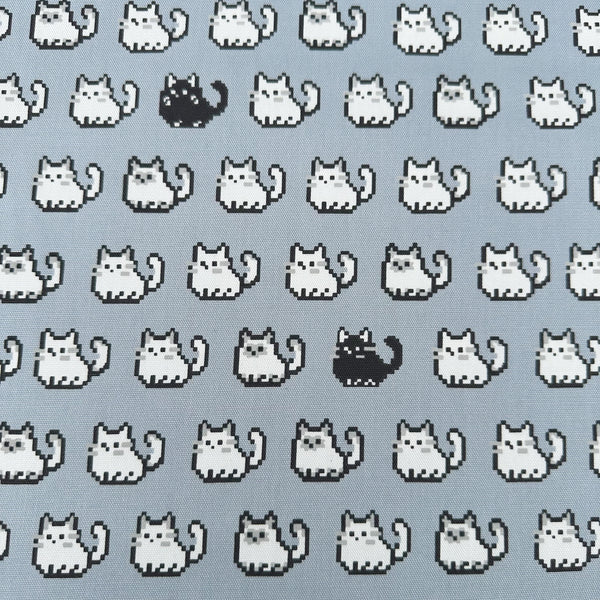 Pixel Cats gray cotton oxford fabric featuring a repeating pattern of pixel-style cat motifs arranged in rows.
