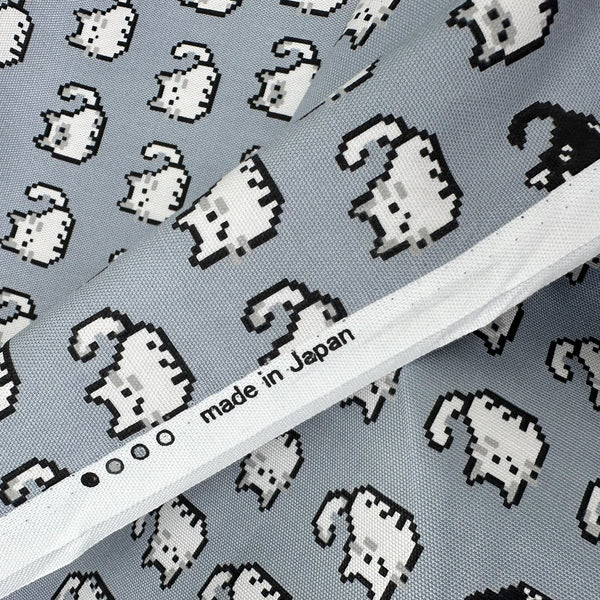 Selvage of Pixel Cats gray cotton oxford fabric featuring a repeating pattern of pixel-style cat motifs arranged in rows.