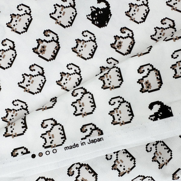 Selvage of Pixel Cats white cotton oxford fabric featuring a repeating pattern of pixel-style cat motifs arranged in rows.