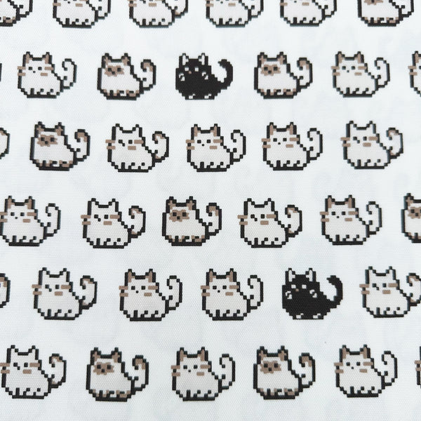 Pixel Cats white cotton oxford fabric featuring a repeating pattern of pixel-style cat motifs arranged in rows.