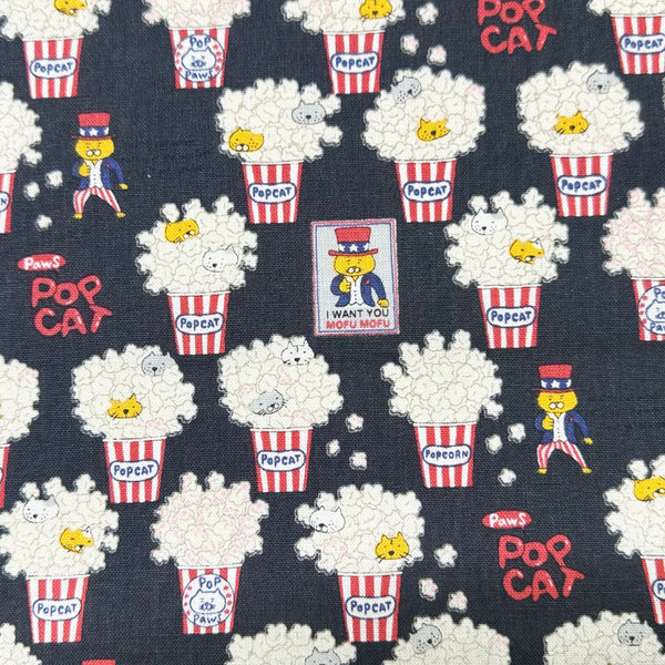 Pop Cat canvas fabric in black cotton linen blend by Cotton Kobayashi featuring cats hiding in popcorn