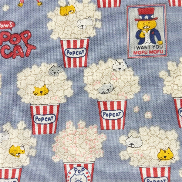 Close up of Pop Cat canvas fabric in gray cotton linen blend by Cotton Kobayashi featuring cats hiding in popcorn 