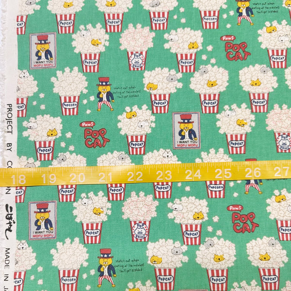 Scale of Pop Cat canvas fabric in green cotton linen blend by Cotton Kobayashi featuring cats hiding in popcorn