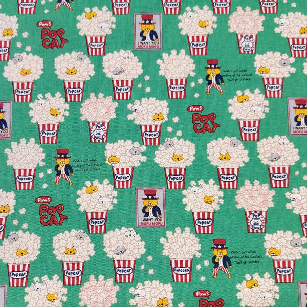 Pop Cat canvas fabric in green cotton linen blend by Cotton Kobayashi featuring cats hiding in popcorn