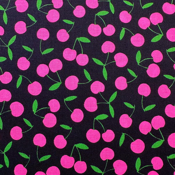 Close up of Pop Cherry cotton fabric with neon pink and black cherries, Japanese import, quilt weight cotton for quilting, apparel, and crafts