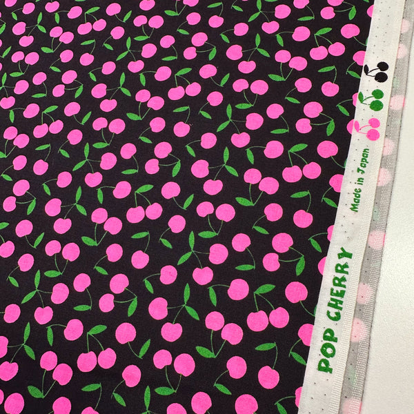Selvage of Pop Cherry cotton fabric with neon pink and black cherries, Japanese import, quilt weight cotton for quilting, apparel, and crafts