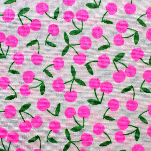 Close up of Pop Cherry cotton fabric with neon pink and white cherries, Japanese Import, quilt weight cotton for sewing and quilting