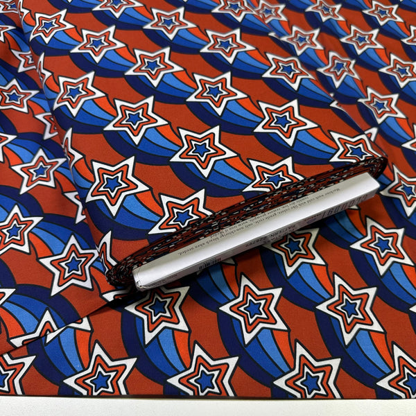 Bolt of Pop Stars Groovy Stars Cotton Fabric by Cloud 9 Fabrics, retro red white and blue star print.
