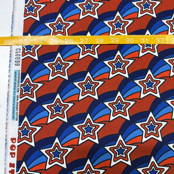 Scale of Pop Stars Groovy Stars Cotton Fabric by Cloud 9 Fabrics, retro red white and blue star print.