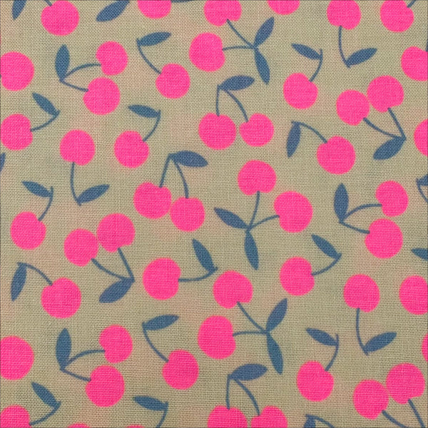 Close up of Pop Cherry Cotton Fabric in Cream and Neon Pink featuring a bold cherry print, imported from Japan.