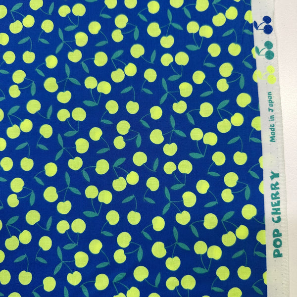 Selvage of Pop Cherry Cotton Fabric in Navy and Neon Yellow featuring a bold cherry print, imported from Japan.