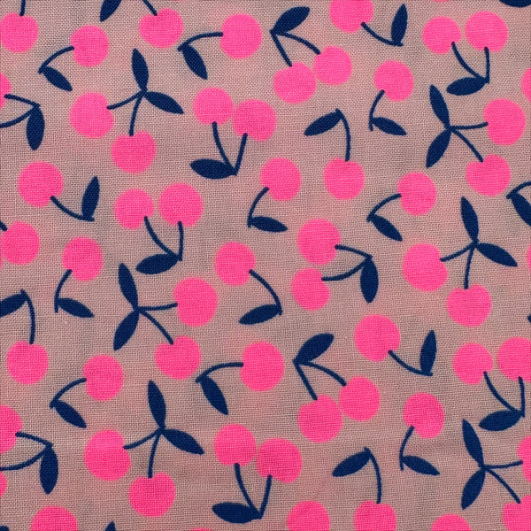 Close up of Pop Cherry Cotton Fabric in Neon Pink and Navy featuring a bold cherry print, imported from Japan.