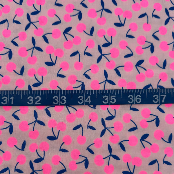 Scale of Pop Cherry Cotton Fabric in Neon Pink and Navy featuring a bold cherry print, imported from Japan.