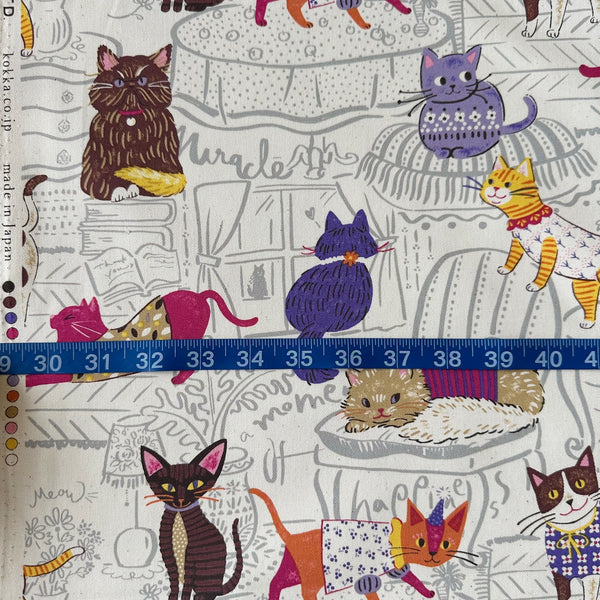 Powerful Animal Cats cotton oxford fabric by Kokka in ivory, style YGA-71000-1A, shown with a tape measure for scale