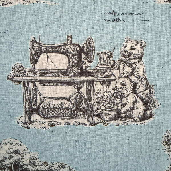 Close up of Rabbit Toile de Jouy cotton fabric in blue