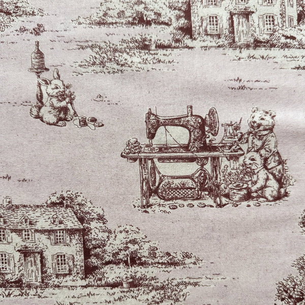 Close up of Rabbit Toile de Jouy cotton fabric in blush brown
