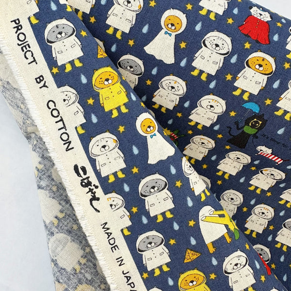 Selvage of Raincoat Cats Cotton Canvas fabric by Cotton Kobayashi, style KTS-7194D, in navy