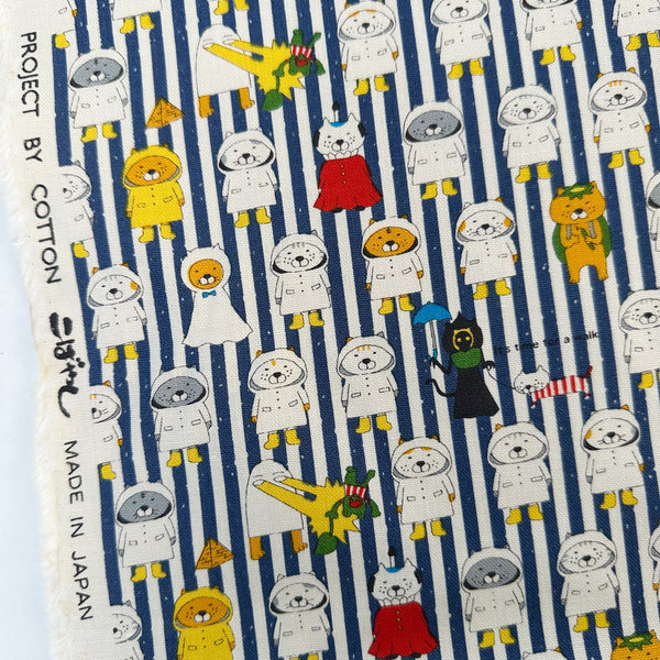 Selvage of Raincoat Cats Cotton Canvas fabric by Cotton Kobayashi, style KTS-7194F, in navy stripe