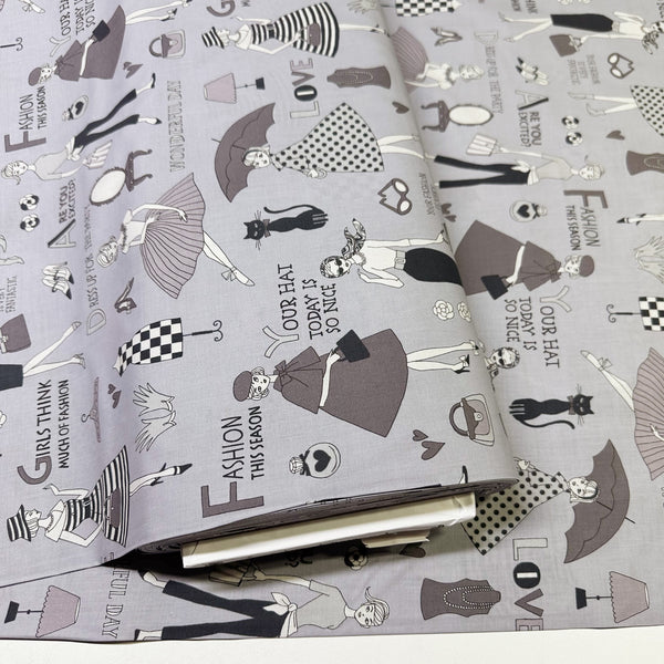 Bolt of Retro Fashionistas cotton fabric in gray featuring 1960s-era fashion ladies by Miyako Kawaguchi for Kei Fabrics