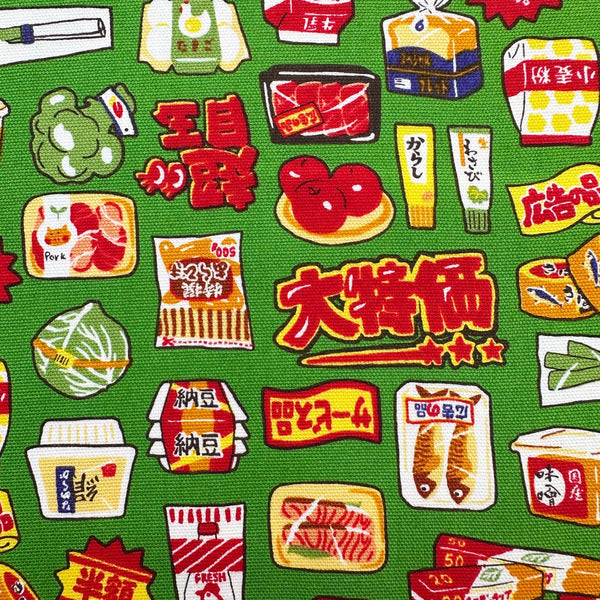 Close up of Retro Japanese Grocery cotton Oxford fabric by Cosmo Textiles featuring vintage-inspired Japanese food packaging and grocery motifs on a green background