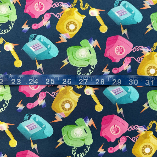 Scale of Ring, Ring cotton fabric by Nora featuring tossed vintage telephones on a blue background, imported from Japan