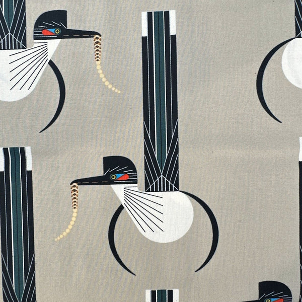 Close up of Road Runner Poplin Fabric by Charley Harper for Birch Fabrics, featuring road runners, on light stone background