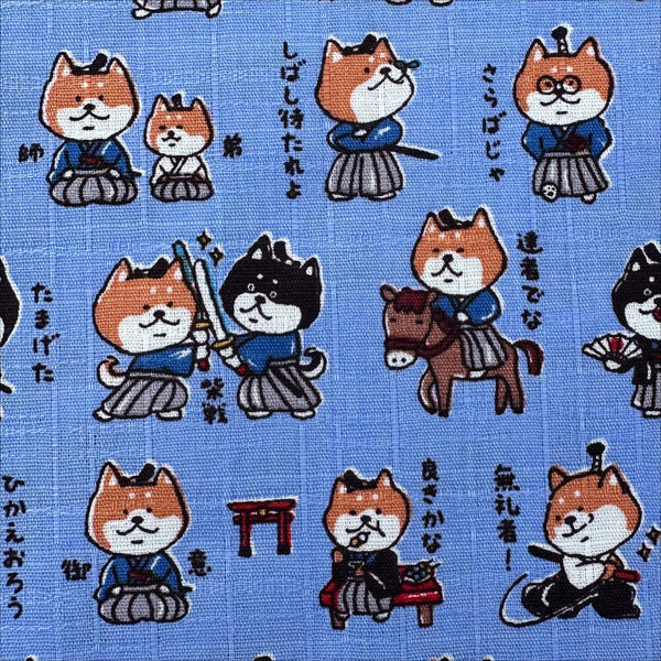 Close up of Samurai Dogs Cotton Dobby Fabric in Blue by Cosmo Textiles Imported from Japan