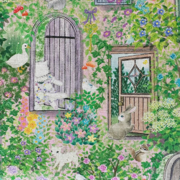 Close up of Secret Garden Cotton Linen Fabric by Yukiemon for Hokkoh featuring whimsical cats, rabbits, and birds peeking from windows and doorways.