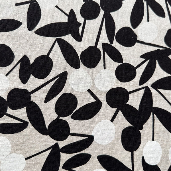 Close up of Black and White Cherry Pom Pom cotton linen canvas fabric by Sevenberry, Japanese import with cherry and pom pom print