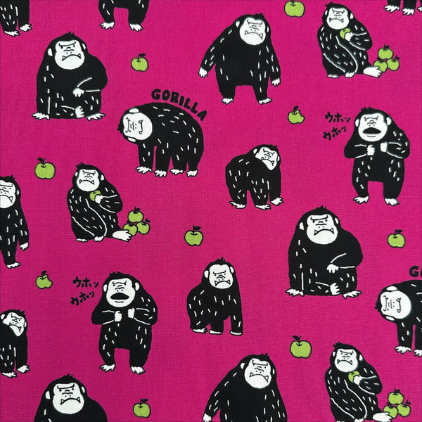 Silly Gorilla Cotton Oxford Fabric in Pink by Cosmo Textiles featuring animated gorillas and apples on a pink background.