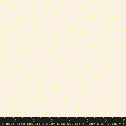 Scale of Starry cotton fabric by Ruby Star Society featuring tiny neon yellow stars.