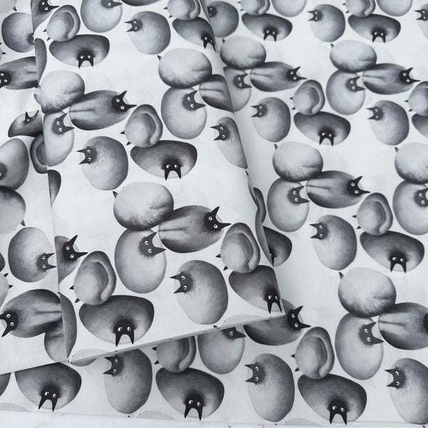 Bolt of Stone Cats cotton fabric in Gray by Nora featuring round stone cats with a quirky, surreal charm and slightly eerie appeal
